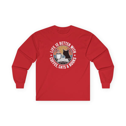 Sunset Reads & Whiskers Long Sleeve shirt featuring a design with coffee, cats, and books, perfect for book lovers.