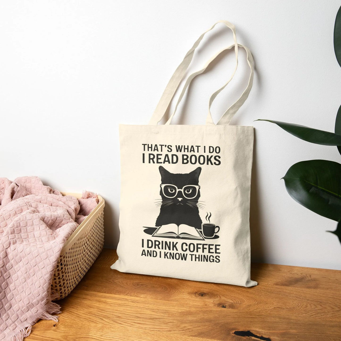Coffee & Cat Wisdom Tote Bag featuring a witty cat illustration and the quote, 'That's what I do I read books, I drink coffee and I know things.'