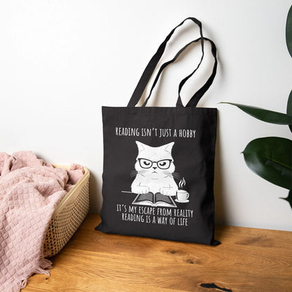 Reading Way of Life Tote Bag featuring a cat design with the quote about reading as a lifestyle, durable canvas material.