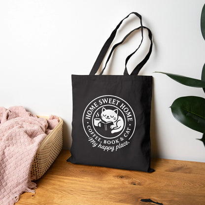 Cozy Cat Haven Tote Bag showcasing a cat with a book and coffee, perfect for book lovers enjoying cozy moments anywhere.