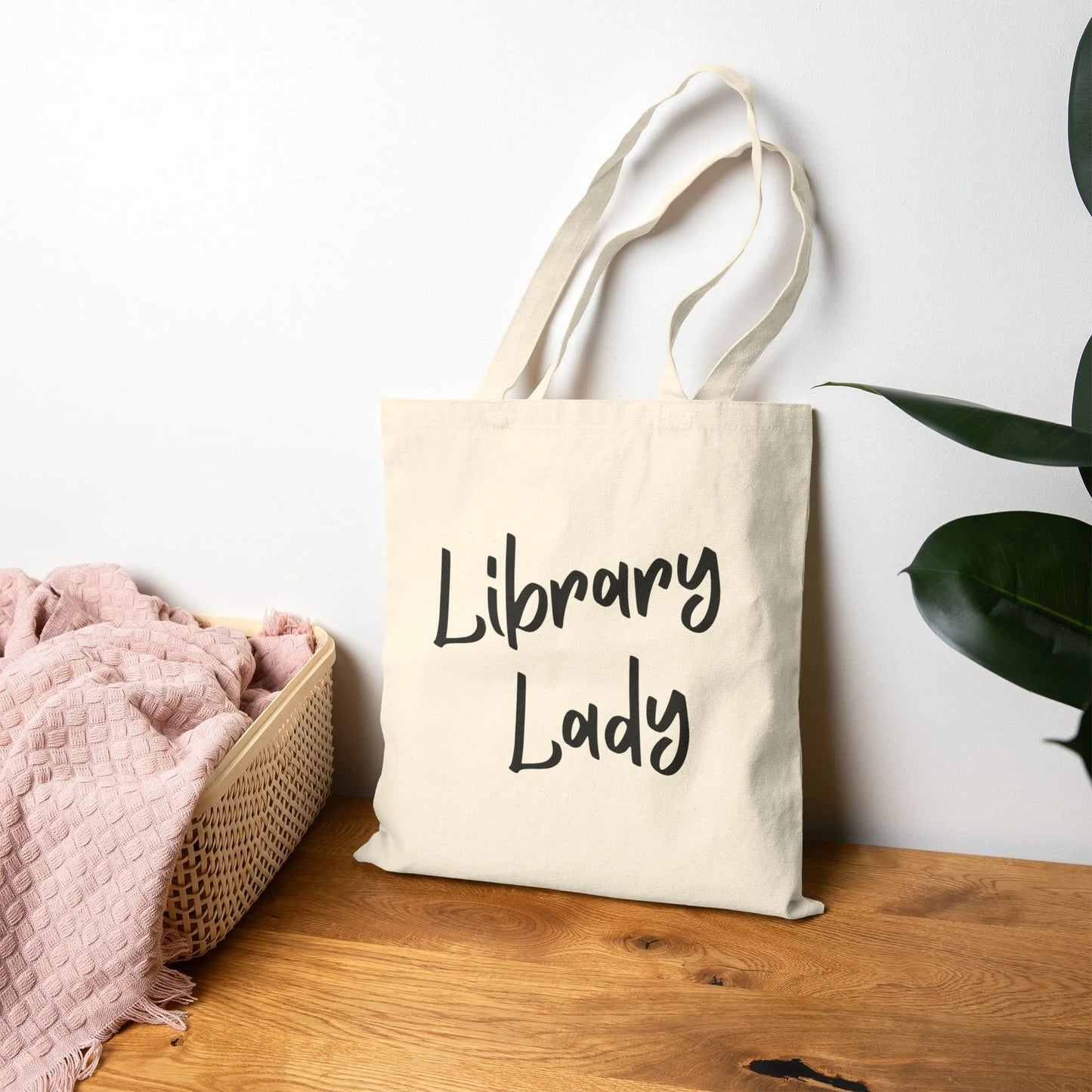 Library Lady Tote Bag with charming handwritten-style typography, perfect for book lovers, coffee and tea enthusiasts.