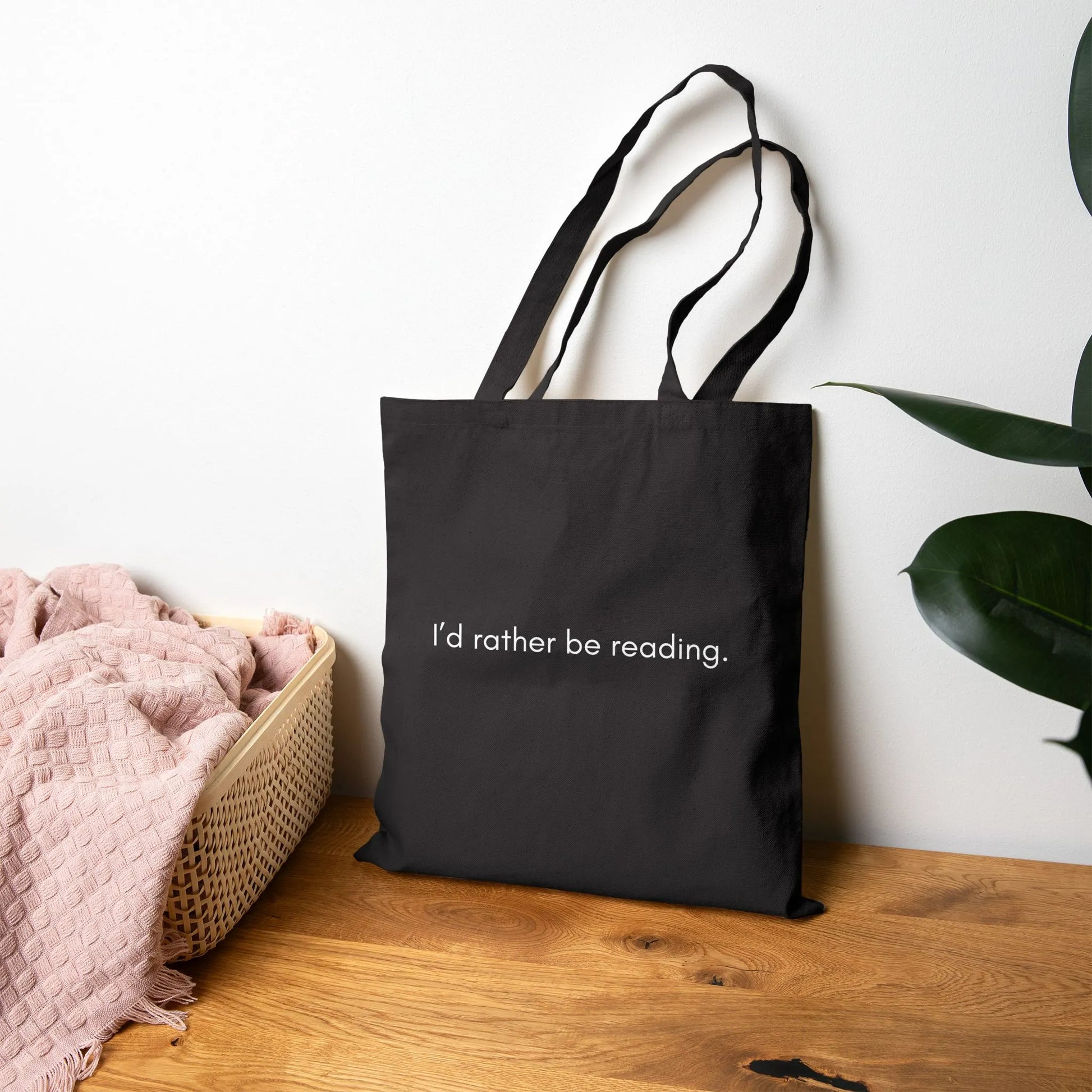 Rather Be Reading Tote Bag in minimalist black, showcasing the quote 'I'd rather be reading', perfect gift for book lovers.