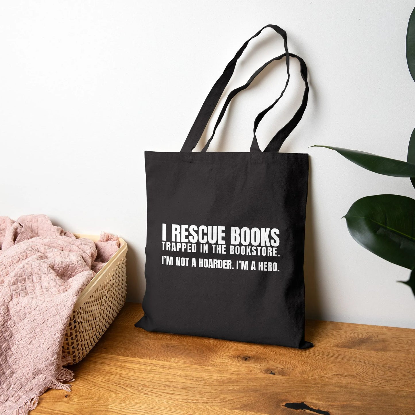 I Rescue Books Tote Bag featuring bold white text, perfect for book lovers and a great gift for readers.