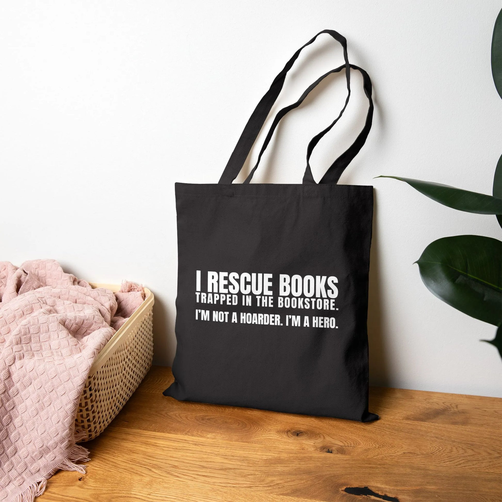 I Rescue Books Tote Bag featuring bold white text, perfect for book lovers and a great gift for readers.