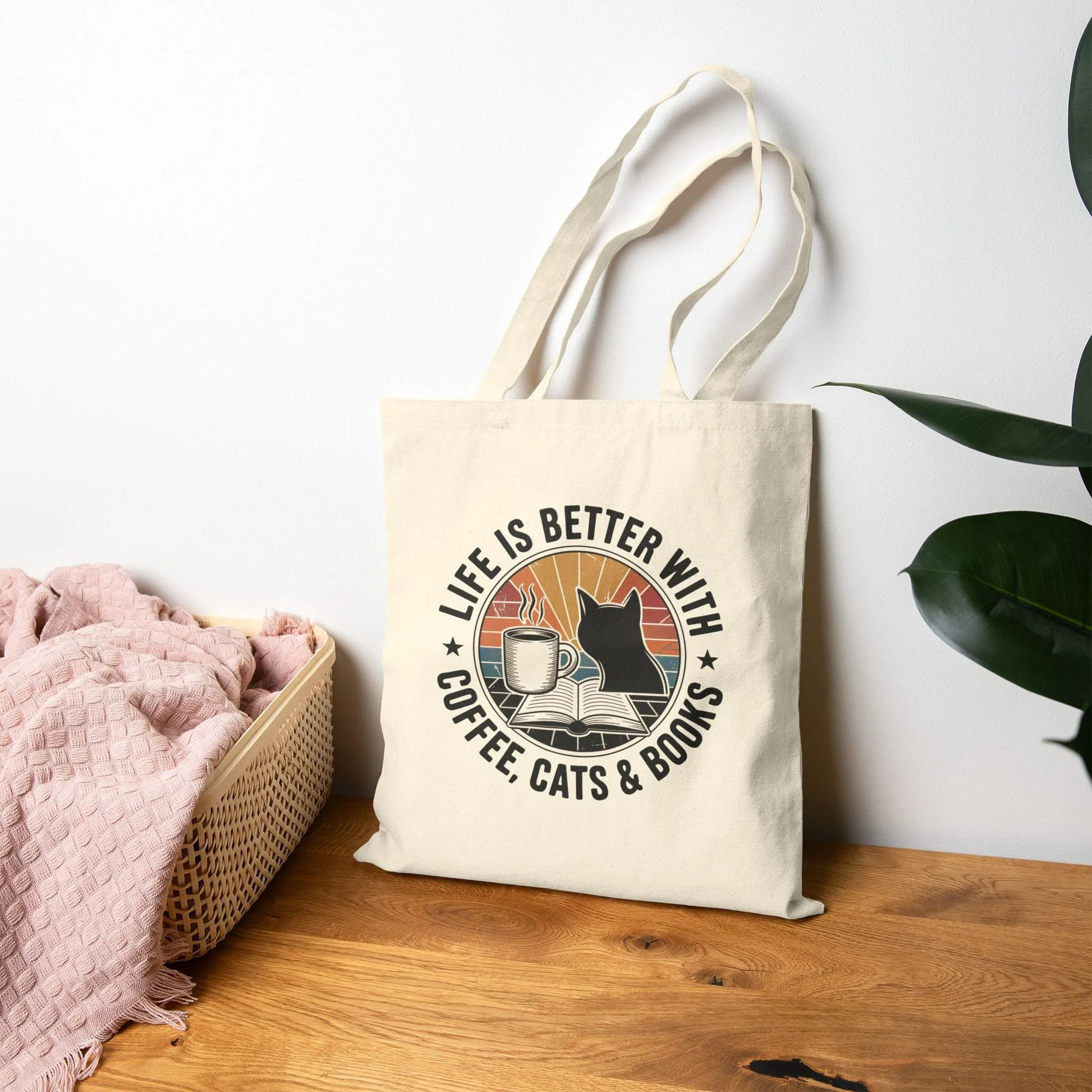 Sunset Reads & Whiskers Tote Bag featuring a retro design with text 'Life is Better with Coffee, Cats & Books', perfect for book lovers.
