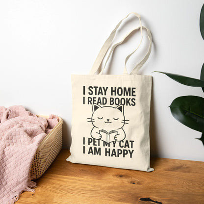 Happy Cat Reader Tote Bag featuring a cute cat illustration with text: 'I STAY HOME I READ BOOKS I PET MY CAT I AM HAPPY'.