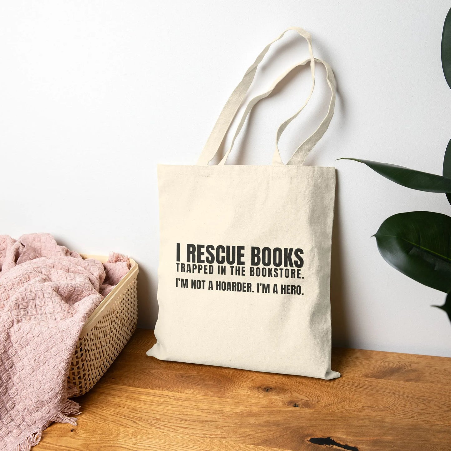 I Rescue Books Tote Bag featuring bold typography saying 'I'm not a hoarder, I'm a hero' for book lovers.