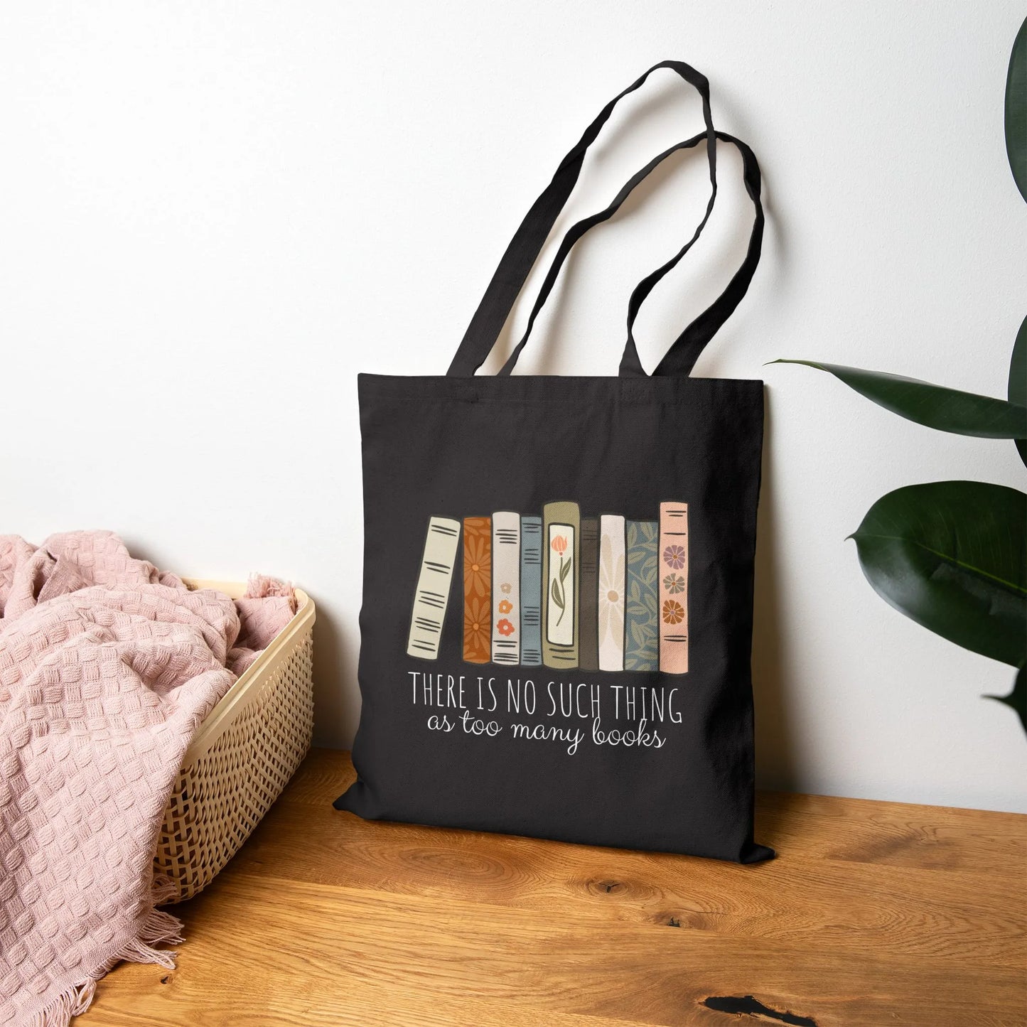 Too Many Books Tote Bag featuring a playful design with book spines and the phrase 'There is no such thing as too many books'.