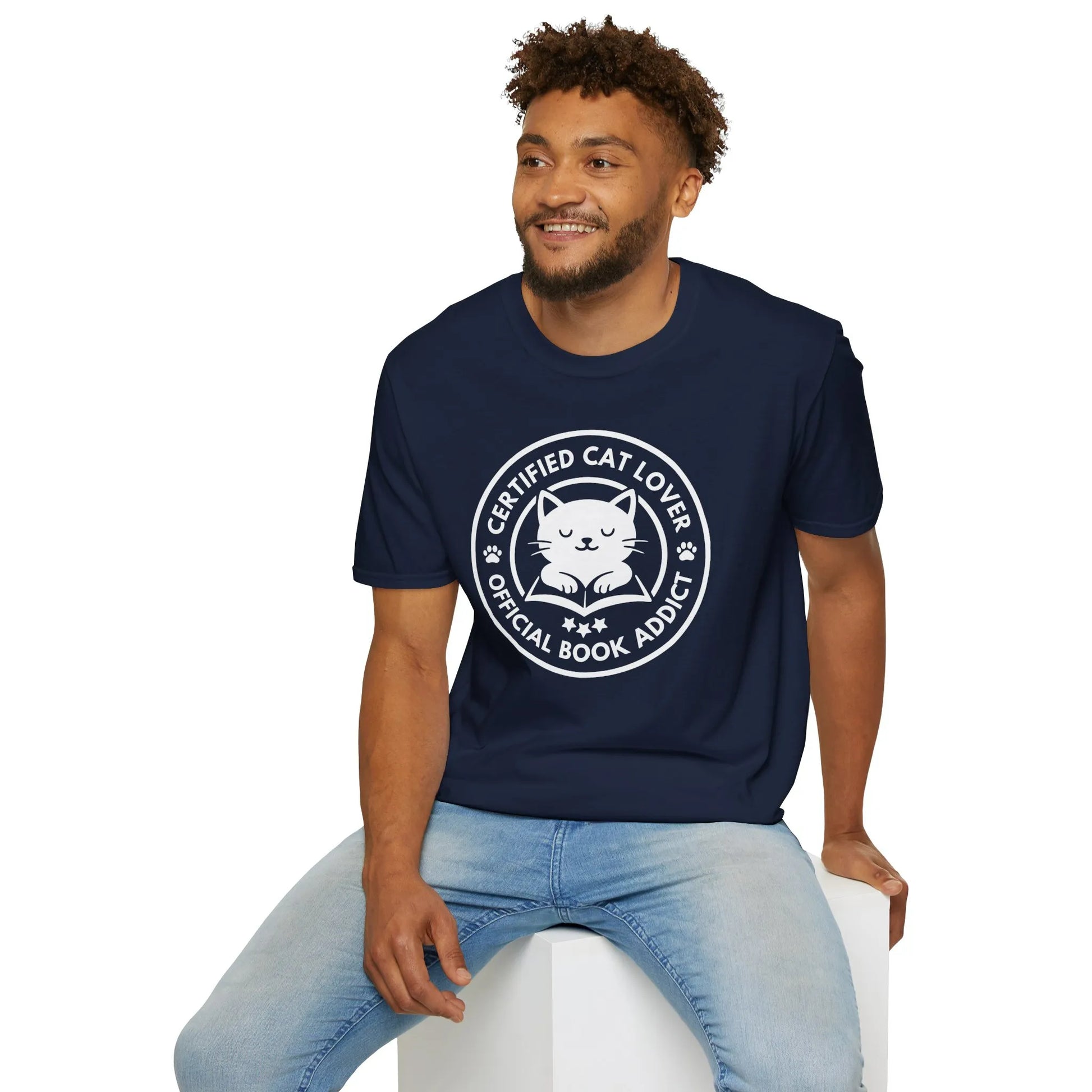 Navy t-shirt featuring a playful design with a cat illustration and text, "Certified Cat Lover, Official Book Addict" – perfect for book lovers.