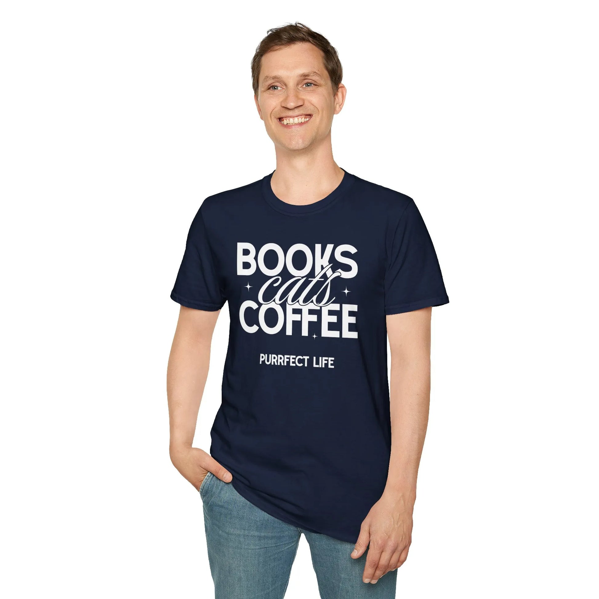 Smiling man in navy Trio of Joy T-Shirt featuring 'Books, Cats, Coffee' and 'PURRfect Life' text, ideal for book lovers.