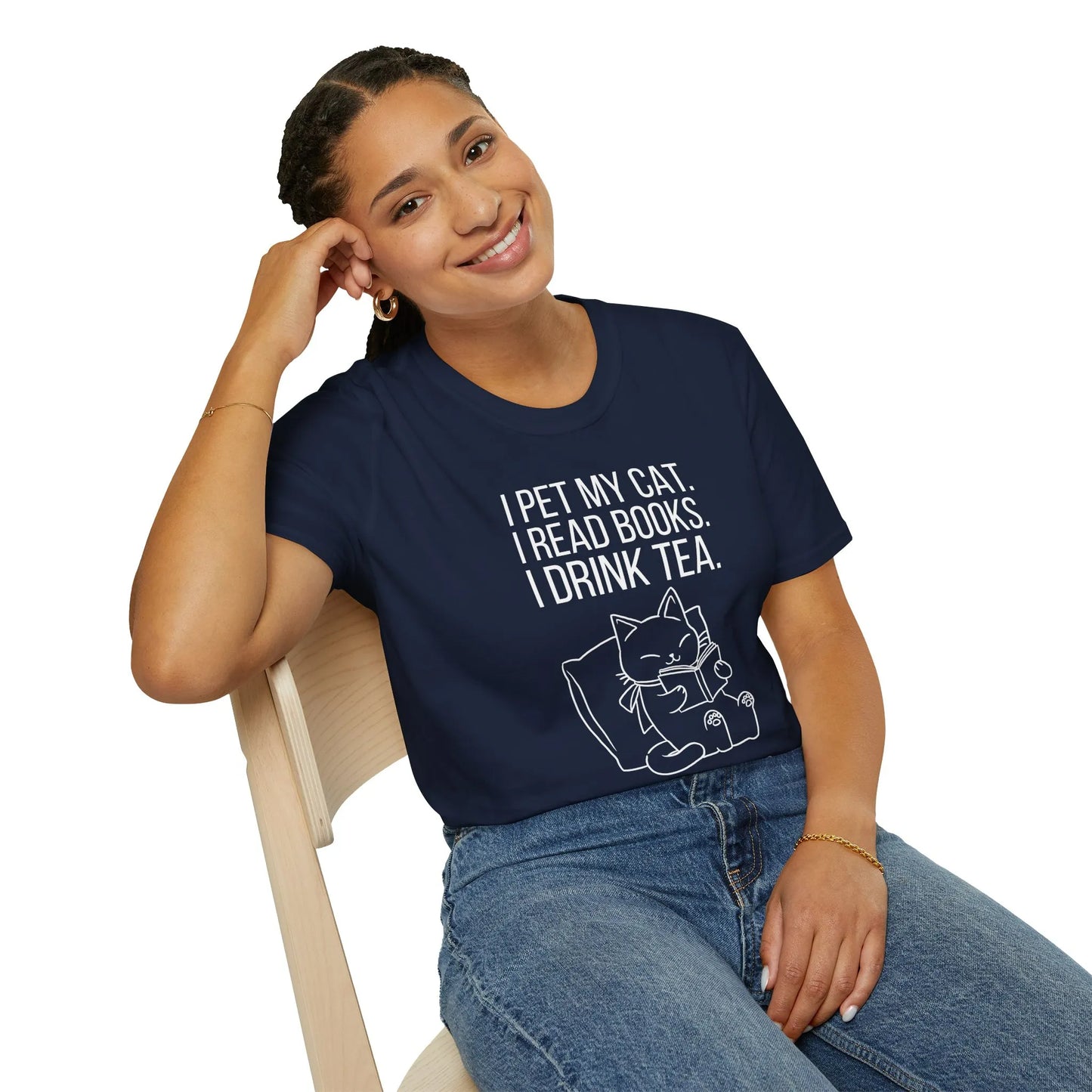 Relaxed fit book lover shirt worn by a woman, cozy home vibe with a cat graphic, perfect for enjoying tea and reading books.