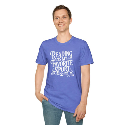 Smiling male in a cozy reading nook wearing a Bookish Athlete T-Shirt, surrounded by books and a cat, celebrating reading lifestyle.