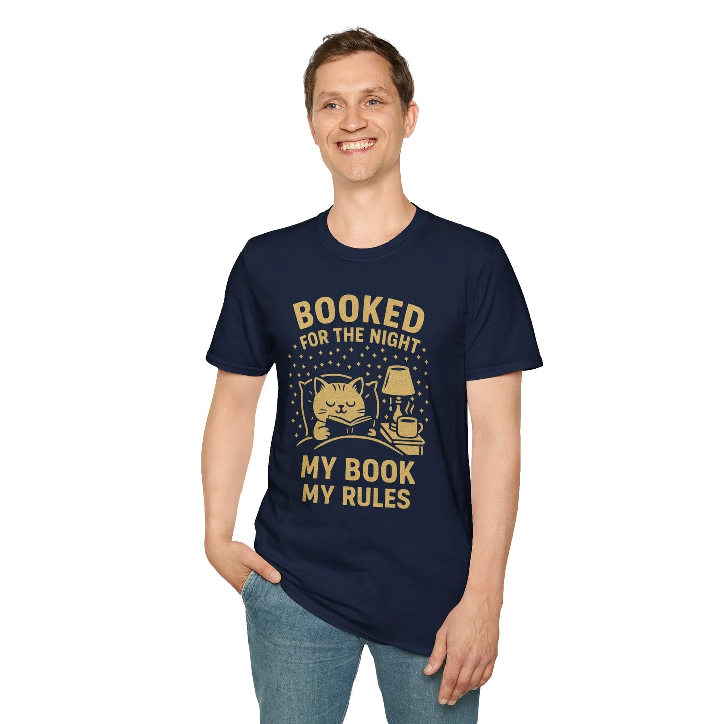 Man wearing a navy t-shirt featuring a cozy cat, lamp, and the text 'Booked for the Night, My Book My Rules'—ideal for book lovers.