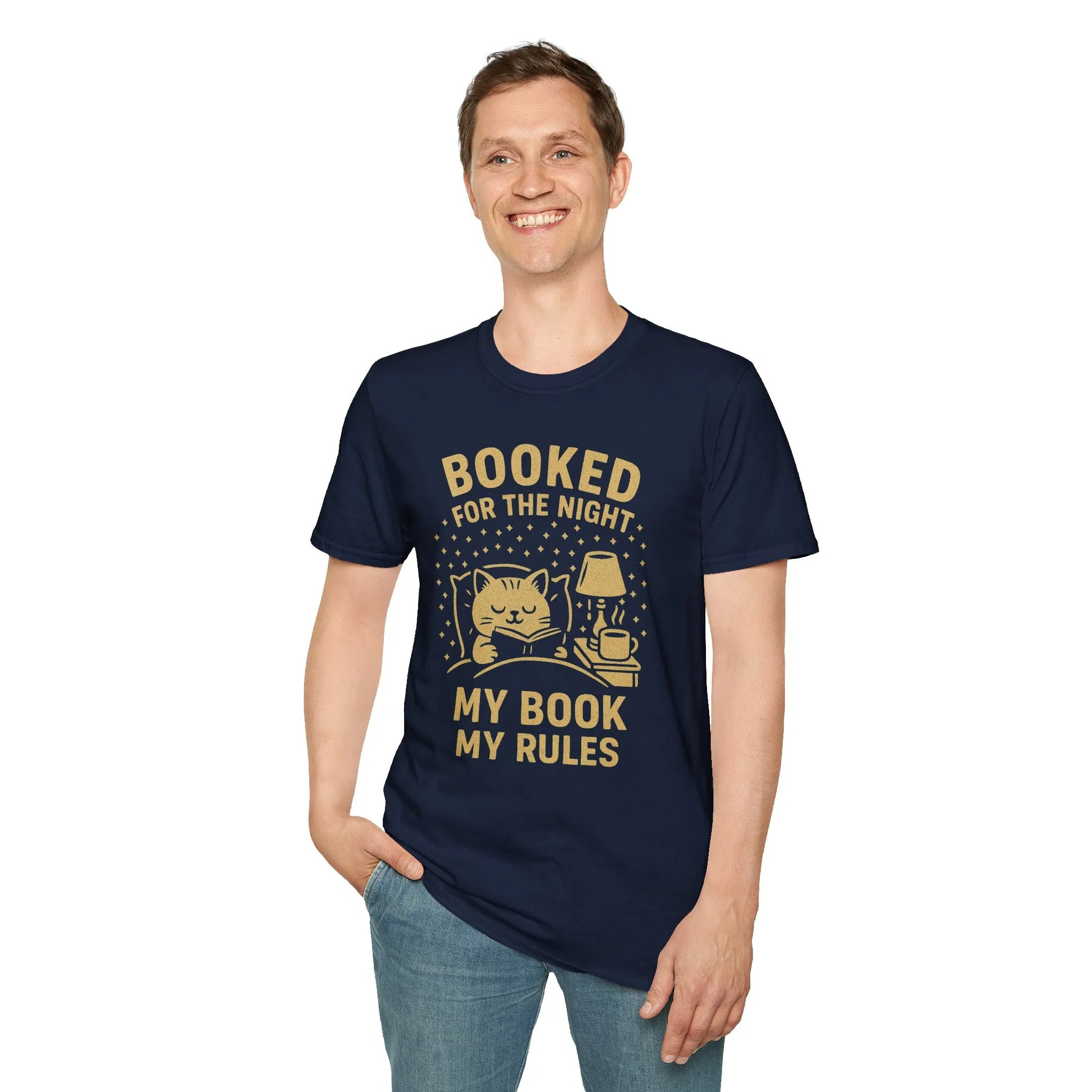 Man wearing a navy t-shirt featuring a cozy cat, lamp, and the text 'Booked for the Night, My Book My Rules'—ideal for book lovers.