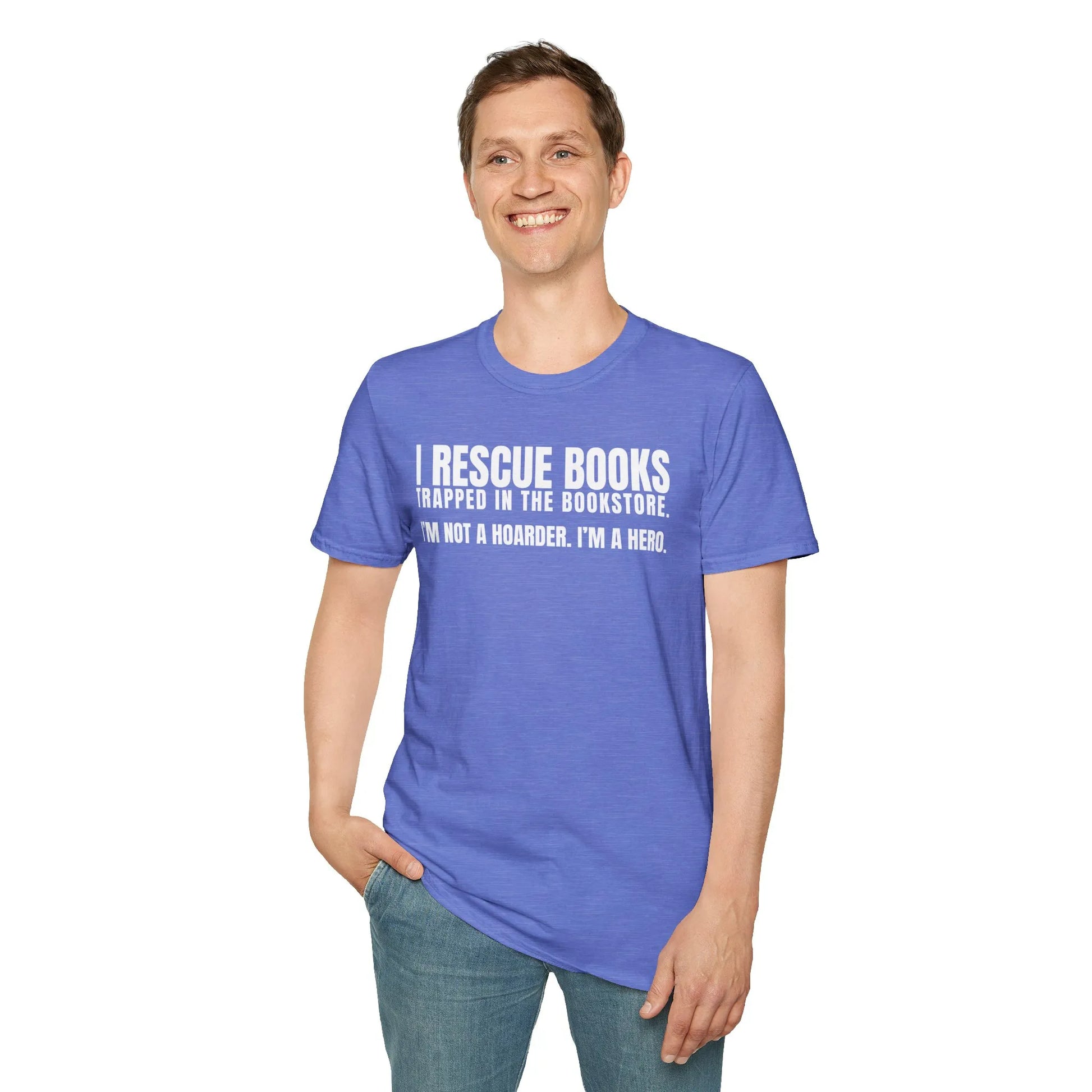 A relaxed fit book lover shirt worn by a smiling man, enjoying a cozy reading lifestyle among books and a cat in a book nook.