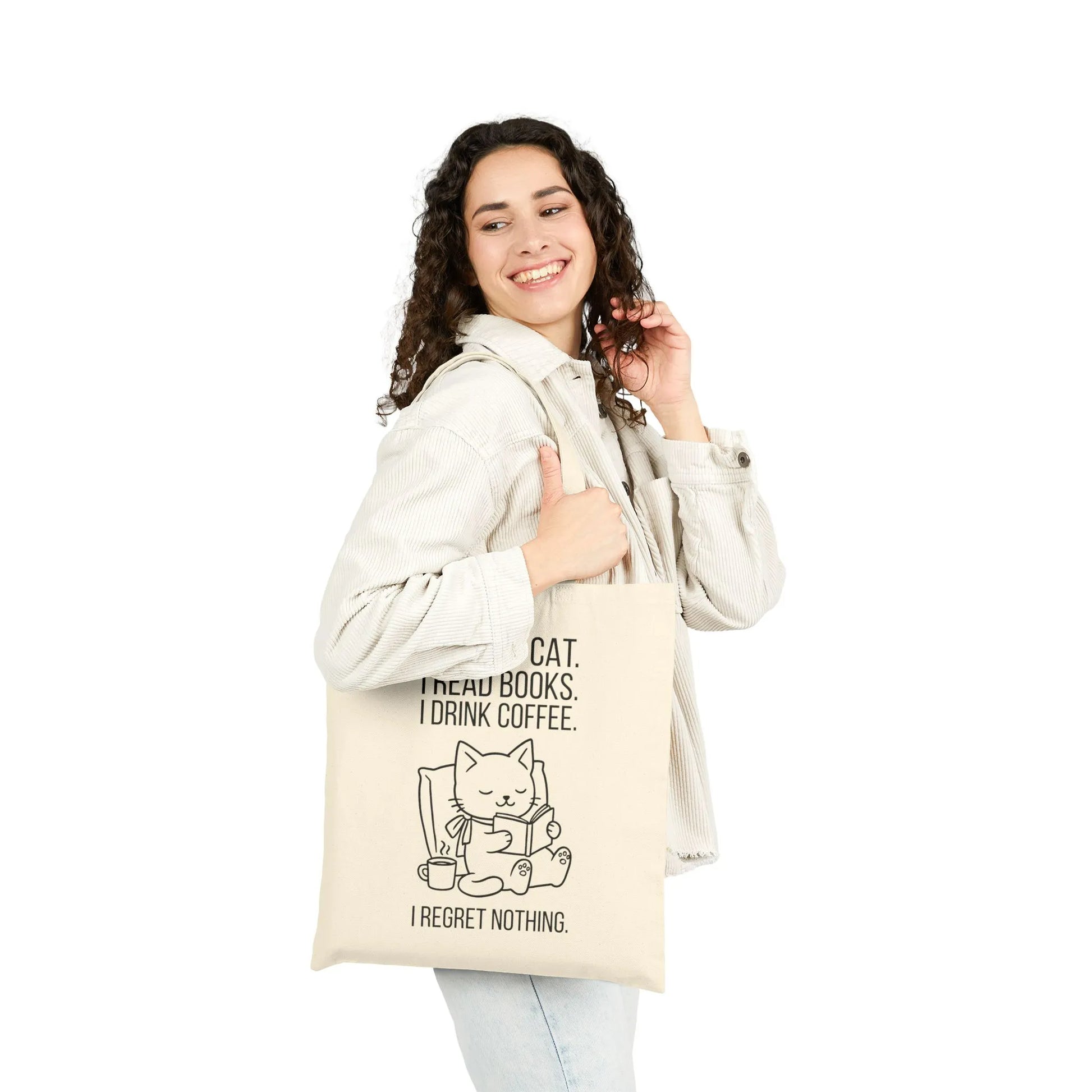 Cheerful person holding a stylish Cat. Books. Coffee. Tote Bag featuring a cat with text about reading and coffee, perfect for cozy book lovers.