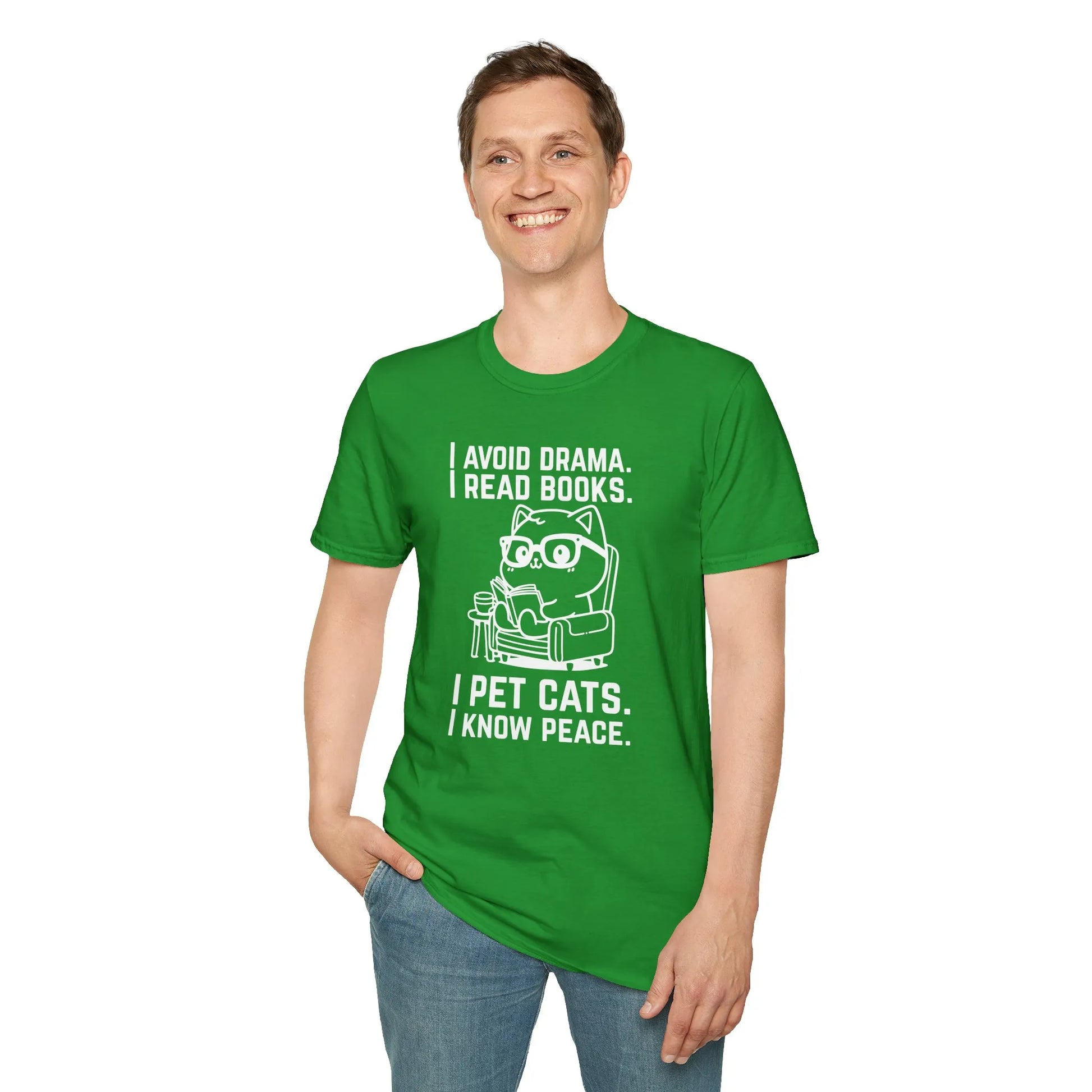 A smiling man in a green t-shirt featuring a cat with glasses, text says 'I avoid drama. I read books. I pet cats. I know peace.' Perfect for book lovers.