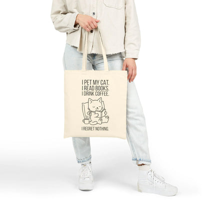 Person holding a Cat. Books. Coffee. Tote Bag featuring a playful cat illustration and humorous reading quote.