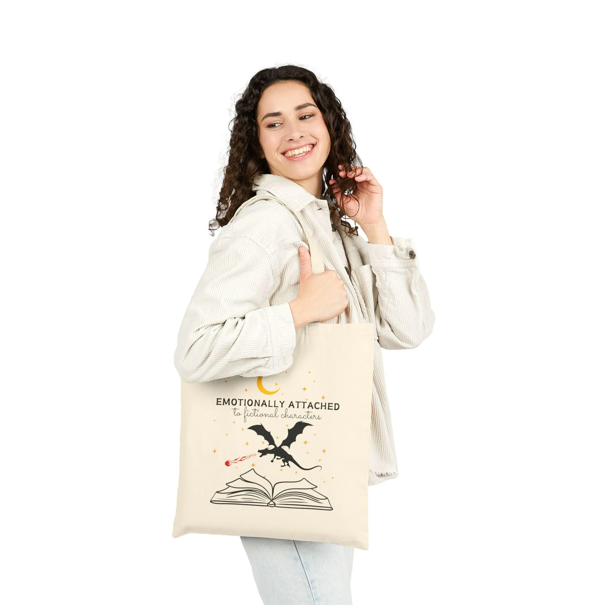 Woman smiling while carrying a Fictional Characters Tote Bag made of durable canvas, featuring a book and dragon design.