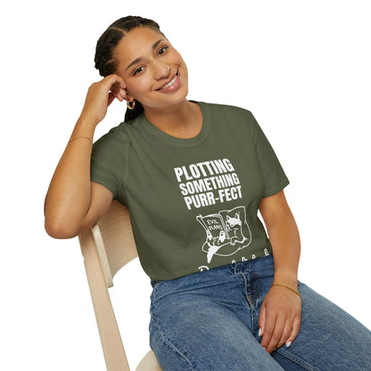 Smiling woman in olive green 'Plotting Something Purr-fect' T-shirt, perfect for cat lovers and bookworms.