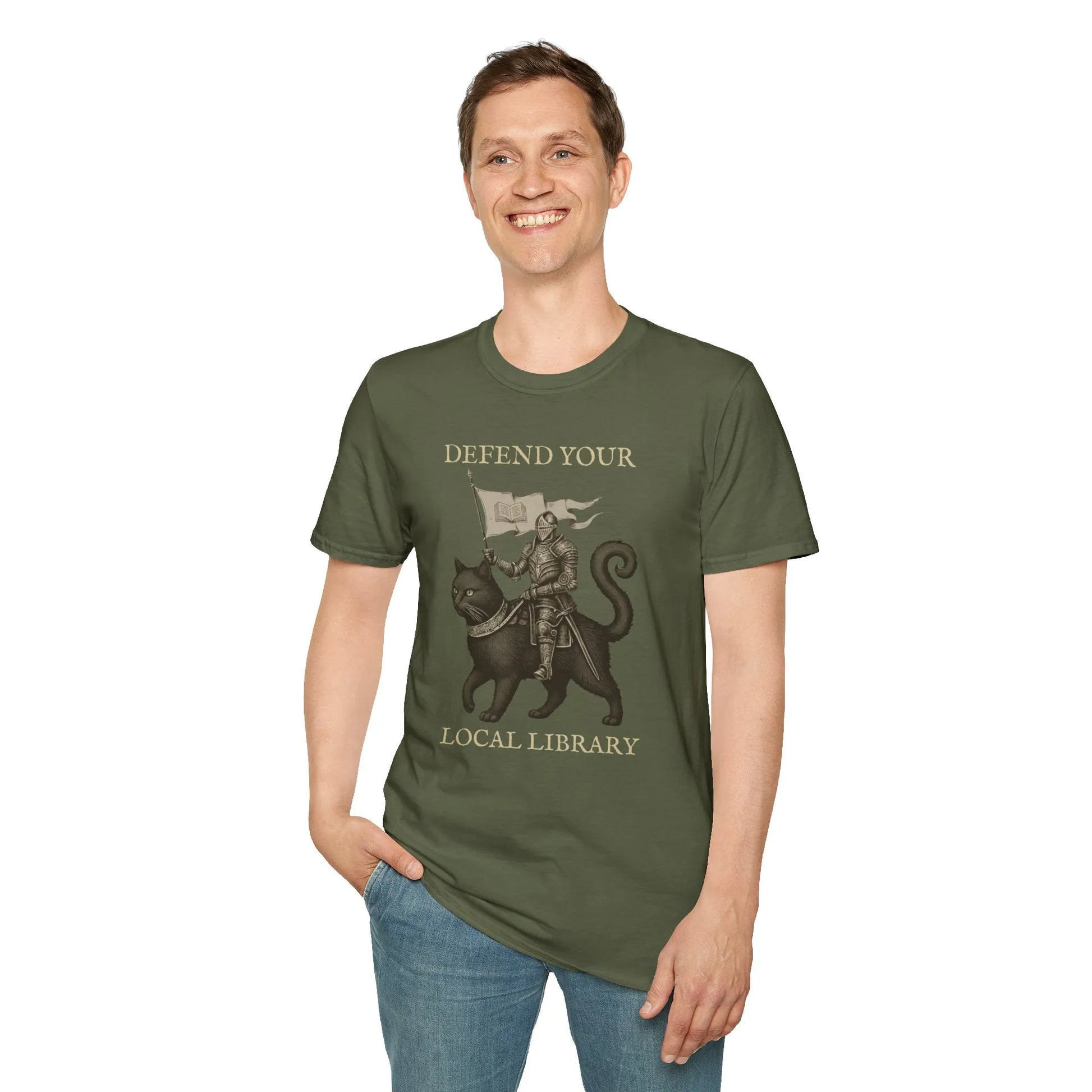 Library Defender T-Shirt features a knight on a cat, humorously proclaiming 'Defend Your Local Library'—a cozy gift for book lovers.