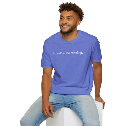Man enjoying a cozy moment in a relaxed fit Rather Be Reading T-Shirt, ideal for book lovers, sipping coffee, surrounded by books.