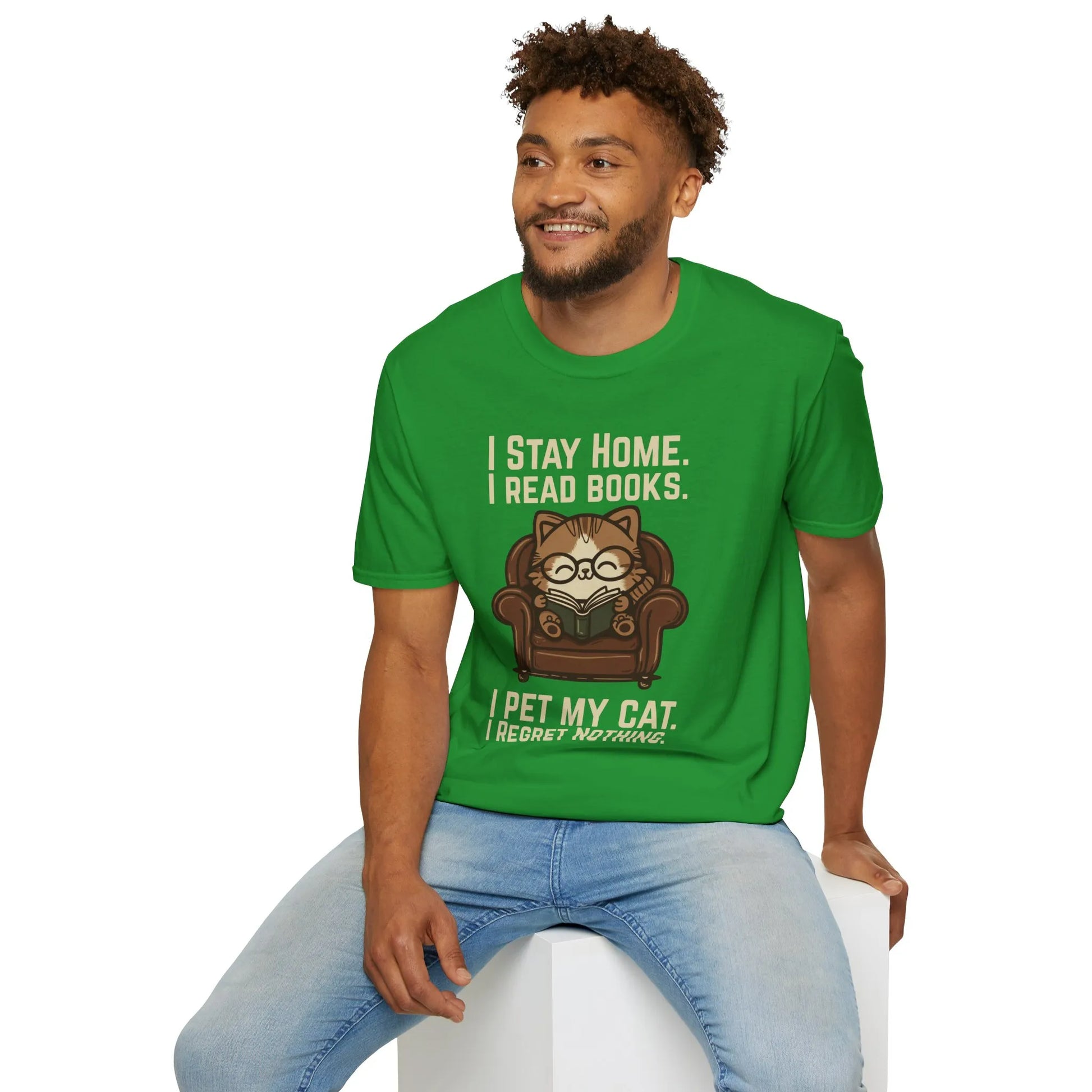 Man wearing an Armchair Cat Reader T-Shirt with a cute cat in glasses on a couch, showcasing bookish humor and cozy vibes.