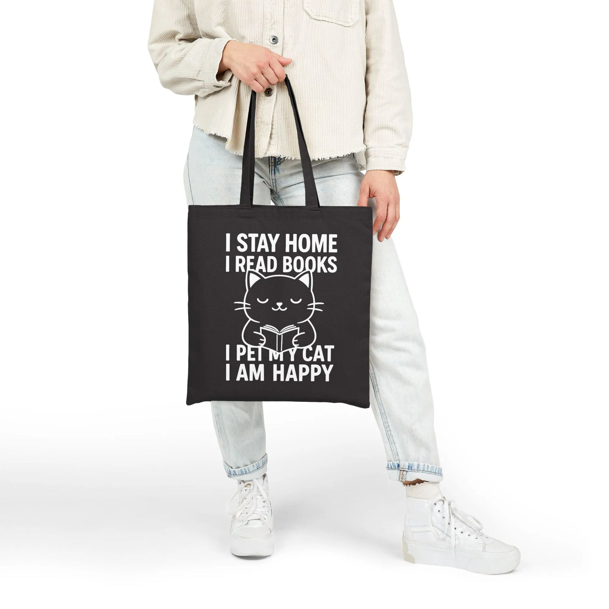 Happy Cat Reader Tote Bag with a cute cat illustration and text: 'I STAY HOME I READ BOOKS I PET MY CAT I AM HAPPY.' Perfect for book lovers!