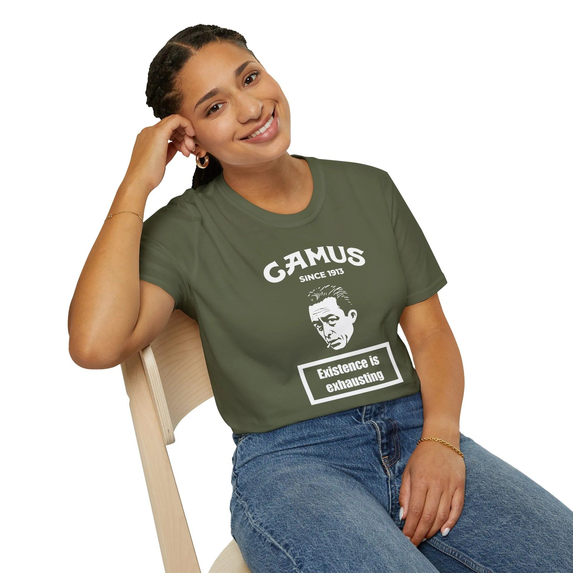 A woman in a cozy green Camus Energy Level T-Shirt featuring the quote 'Existence is exhausting'—perfect for literary fans.