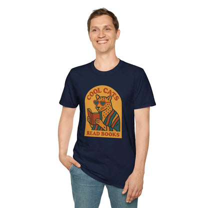 A smiling man wearing a Cool Cats Read Books t-shirt featuring a cat reading, perfect for book lovers and cozy attire.