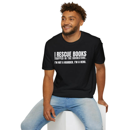A relaxed fit I Rescue Books T-Shirt worn by a smiling individual, perfect for cozy reading with cats and a warm beverage, symbolizing book lover lifestyle.