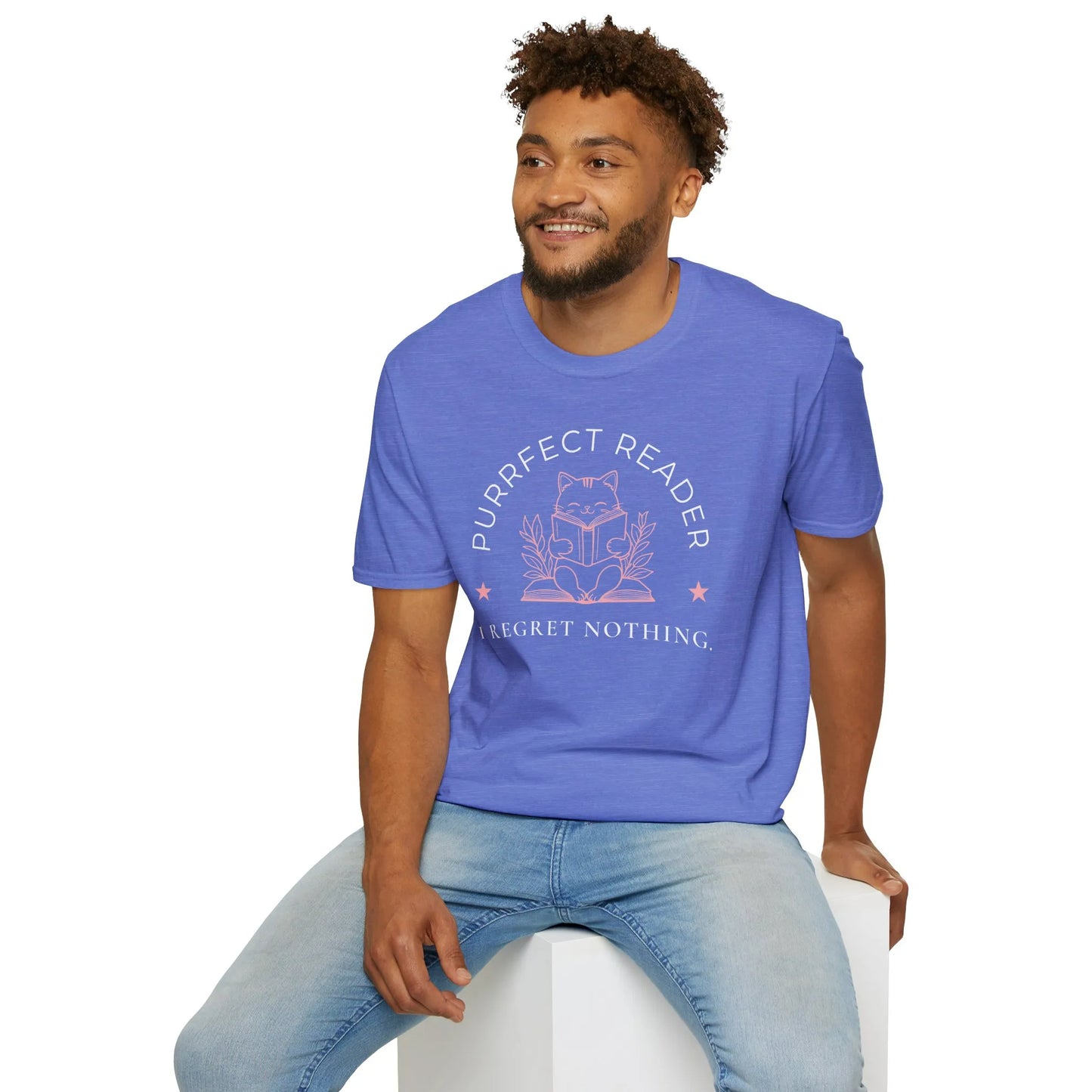 A smiling man wearing a blue Purrfect Reader 2 T-Shirt with a cute cat illustration and the text "I Regret Nothing," perfect for book lovers.