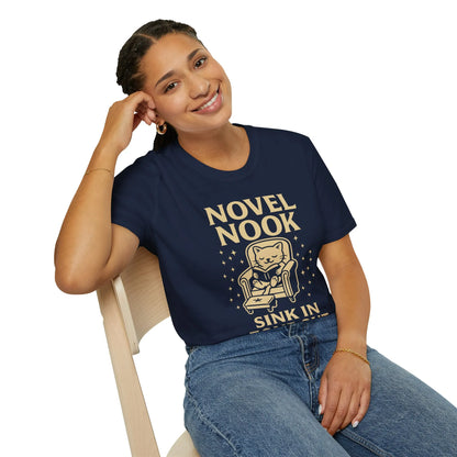 Cozy cat in an armchair graphic on a Novel Nook tee, perfect for book lovers and a great gift for readers.
