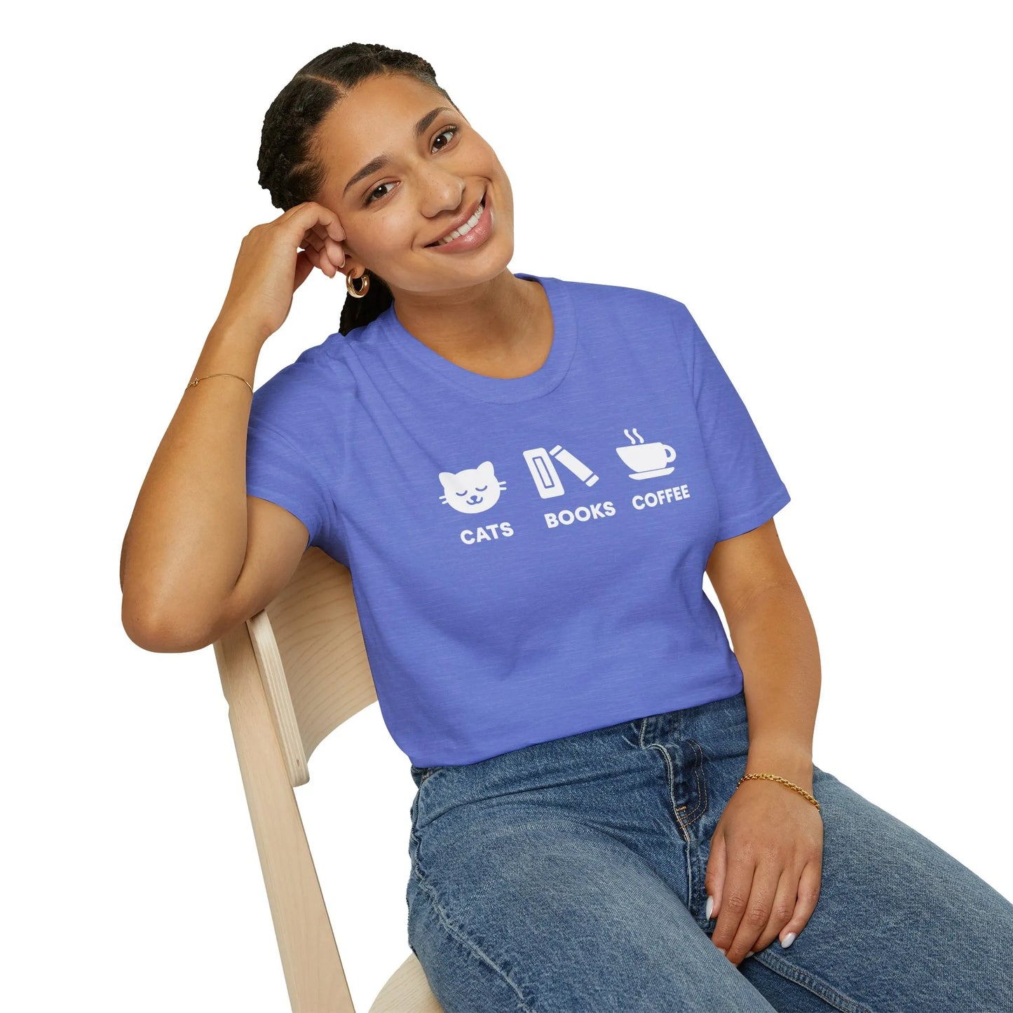 A woman in a cozy reading tee featuring cat, book, and coffee icons, embodying a relaxed lifestyle for book lovers in organic cotton.