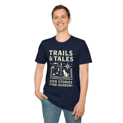 Man wearing a Trails & Tales t-shirt featuring mountains, stars, and a cat with the text 'Seek Stories, Find Wisdom'.