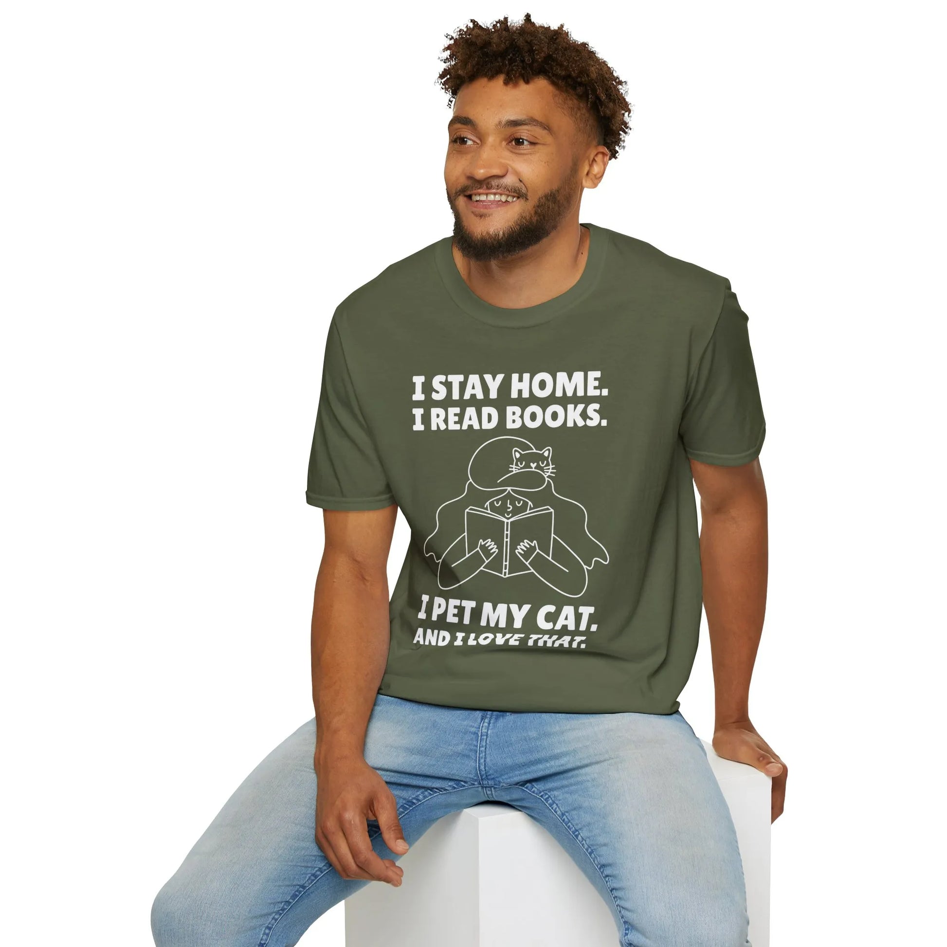 A cozy olive-green t-shirt featuring the text "I STAY HOME. I READ BOOKS. I PET MY CAT. AND I LOVE THAT." Perfect for book and cat lovers!