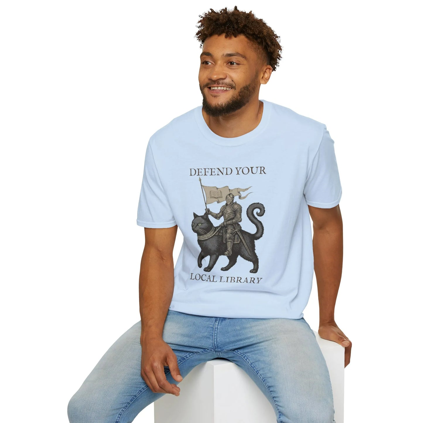 Library Defender T-Shirt features a knight on a cat with the text 'Defend Your Local Library'—perfect book lover shirt!