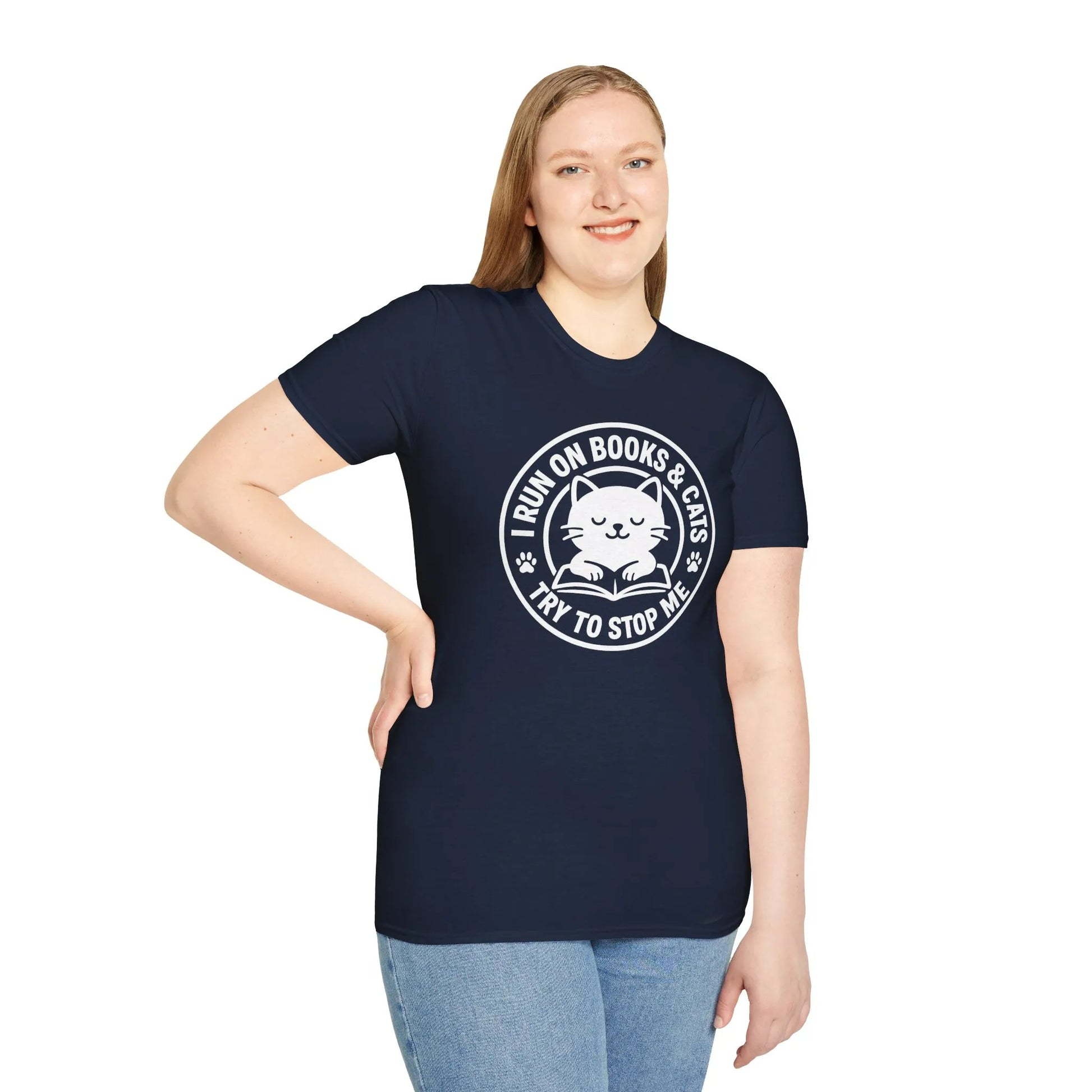Woman wearing a navy t-shirt featuring a cat illustration and the text 'I RUN ON BOOKS & CATS, TRY TO STOP ME!' Perfect gift for book lovers.