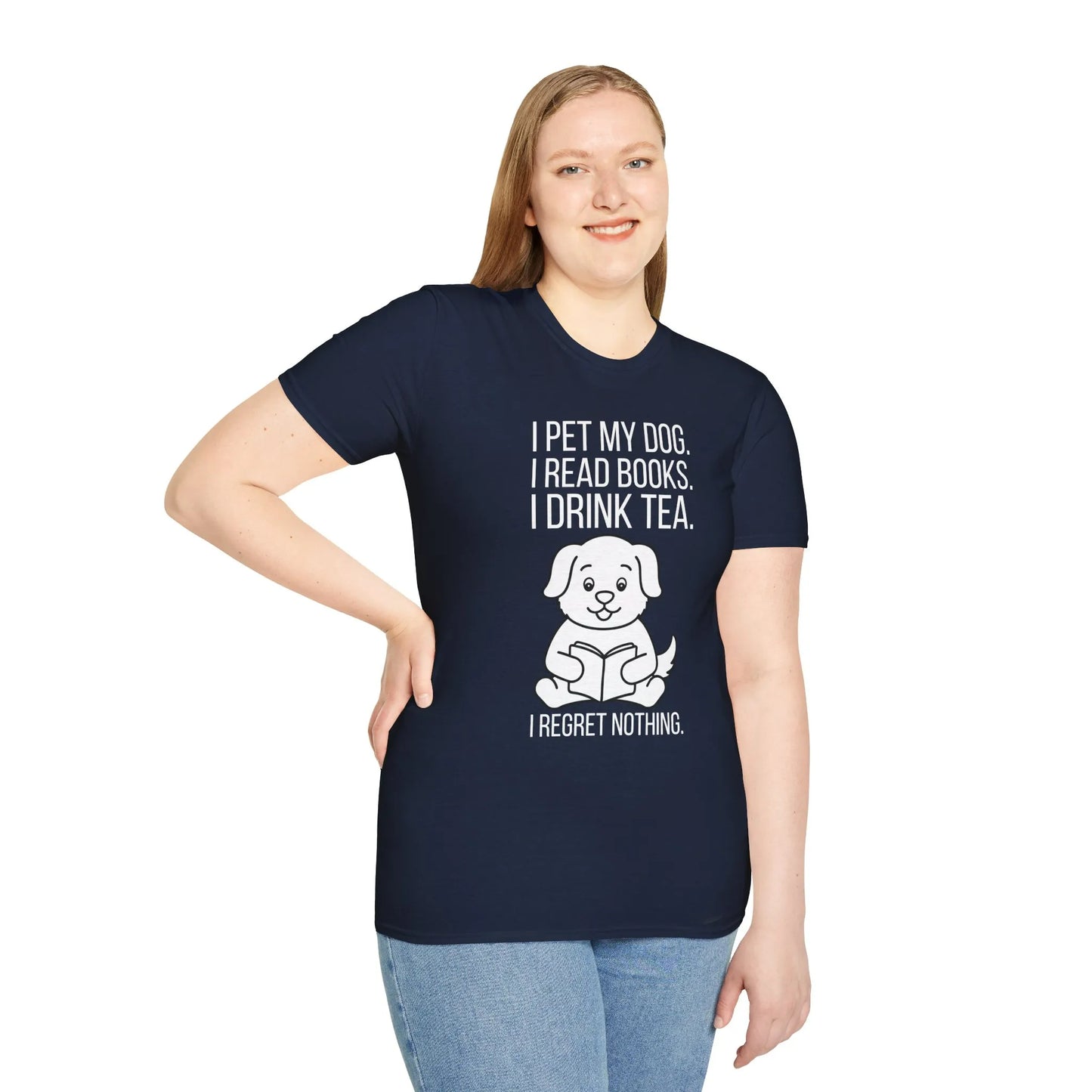 A cozy reading scene featuring a woman wearing a Tea, Tales & Tail Wags T-Shirt, enjoying a book and tea—a perfect gift for book lovers.