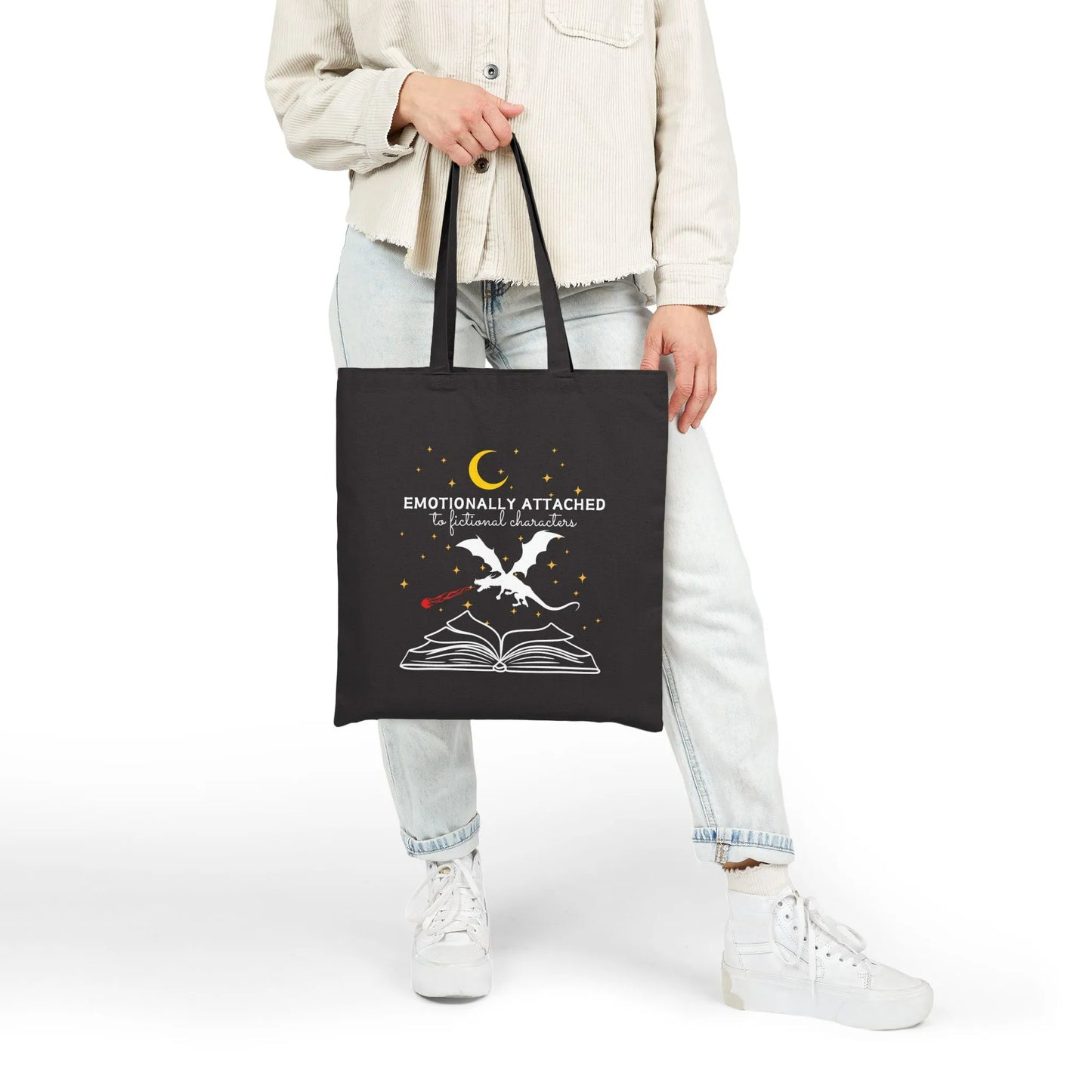 Fictional Characters Tote Bag featuring a design with a book and whimsical imagery, durable black canvas material.