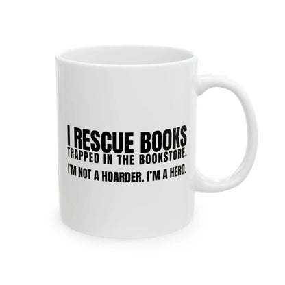 I Rescue Books Mug with bold text: 'I RESCUE BOOKS TRAPPED IN THE BOOKSTORE. I'M NOT A HOARDER. I’M A HERO.' Perfect for book lovers!