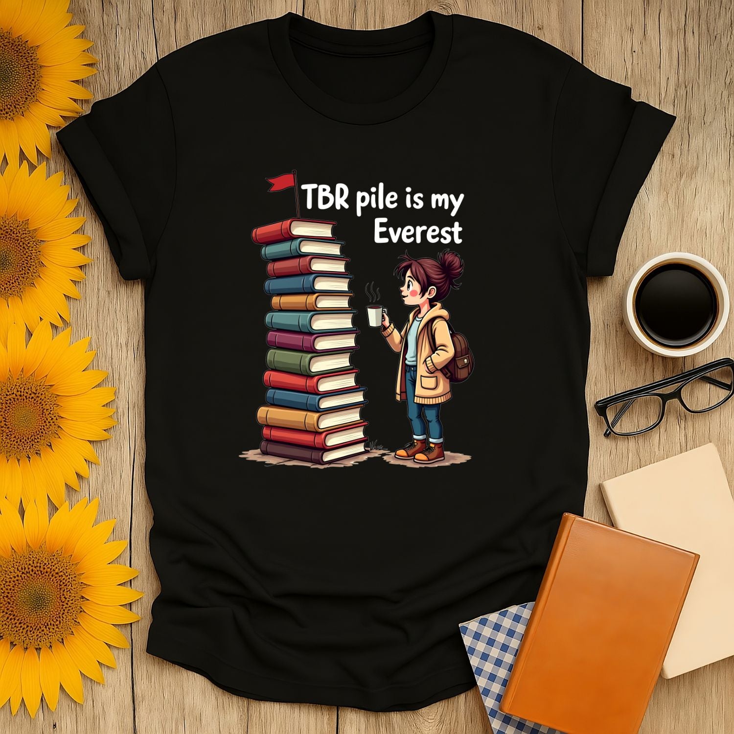 Bookish Everest T-shirt featuring a character with a stack of books, perfect for book lovers and reading enthusiasts.