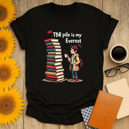 Bookish Everest T-shirt featuring a character with a stack of books, perfect for book lovers and reading enthusiasts.