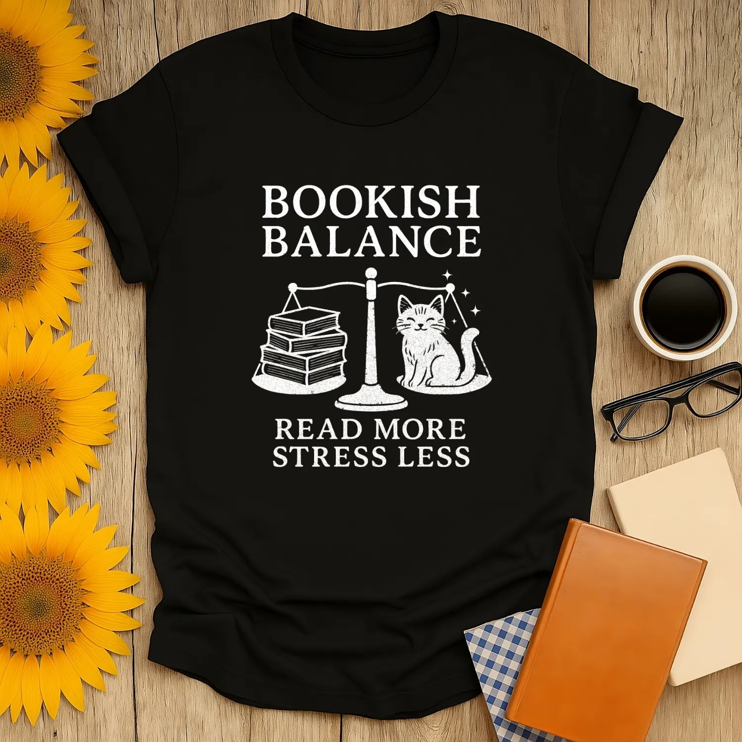 Bookish Balance T-shirt featuring a charming cat beside books and the phrase 'Read More, Stress Less'—perfect for book lovers!