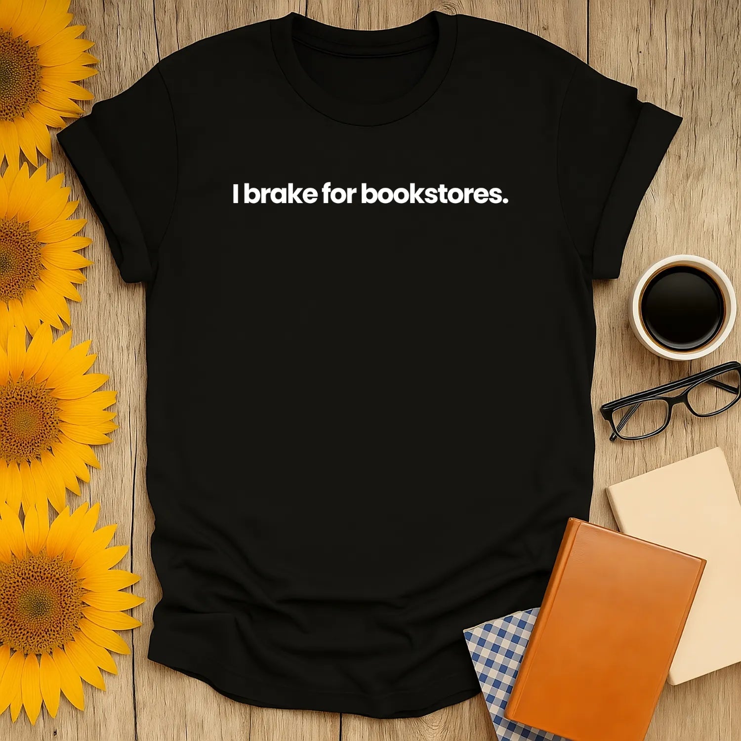 Brake for Bookstores T-Shirt on a rustic table, relaxed fit black tee perfect for book lovers and introverts 📖☕️
