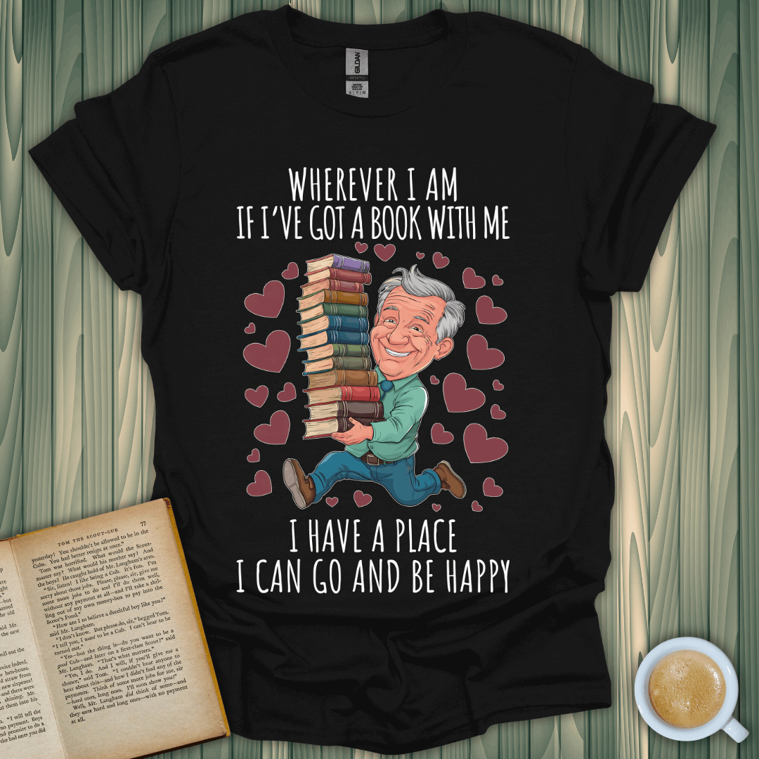 Wherever I am book lover t-shirt featuring a man joyfully carrying stacks of books amidst hearts.