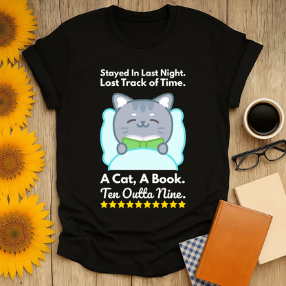 Cozy black t-shirt featuring a cute cat reading, with text: "A Cat, A Book. Ten Outta Nine." Perfect for book lovers and cat fans!