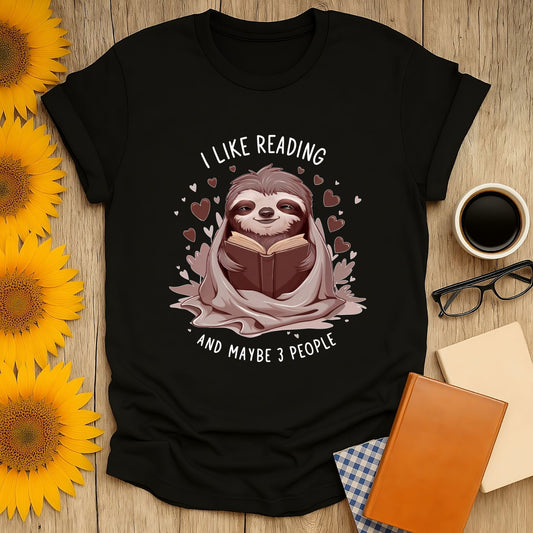 Black t-shirt featuring a sloth reading with text 'I Like Reading and Maybe 3 People', perfect for book lovers.