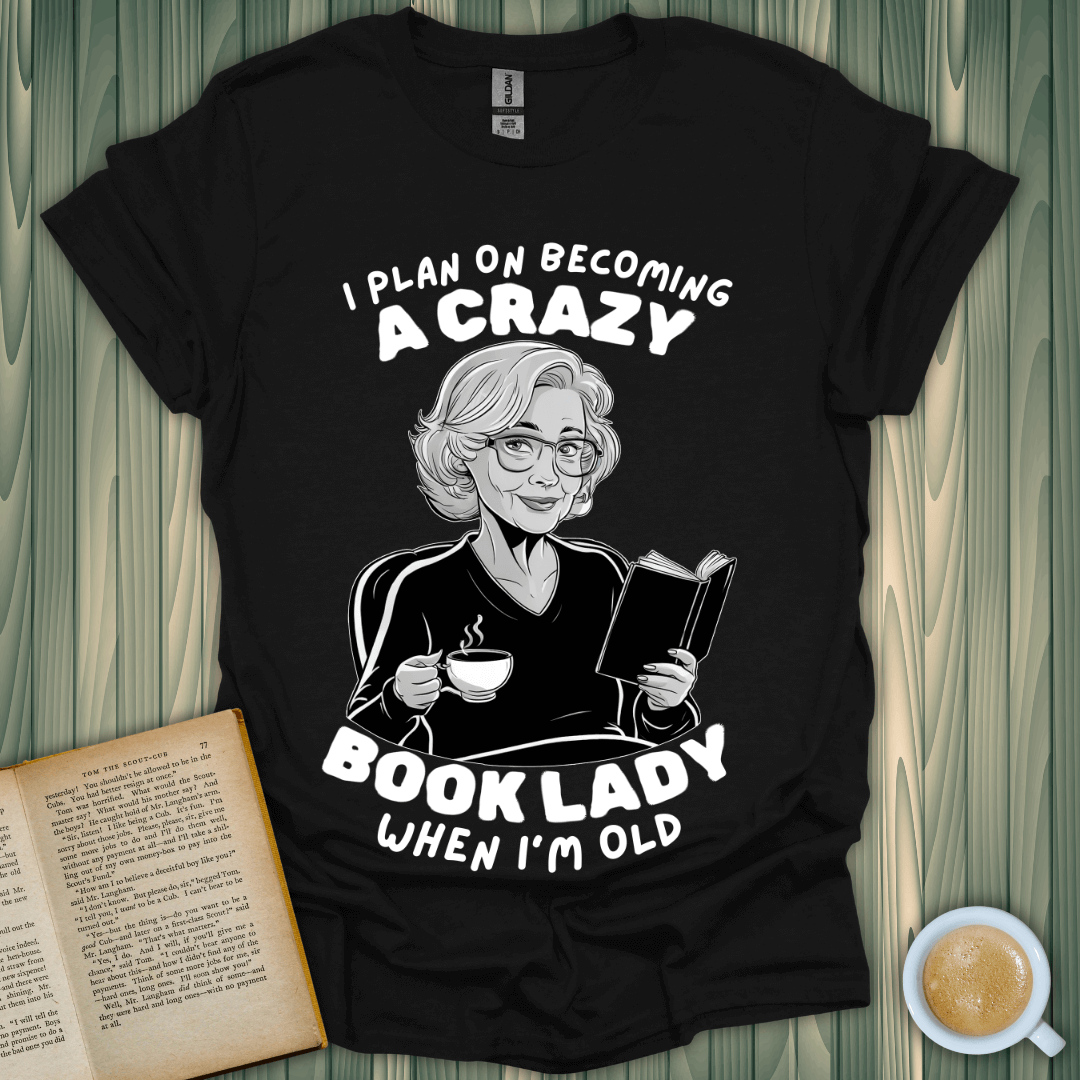 Funny black t-shirt for book lovers with 'Crazy Book Lady' design and a woman enjoying tea while reading.