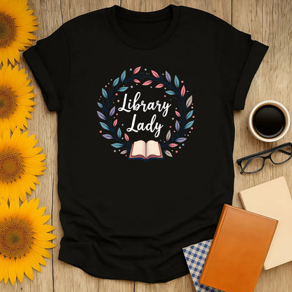 Library Lady t-shirt with book illustration and wreath, perfect gift for book lovers who enjoy cozy reads and humor.